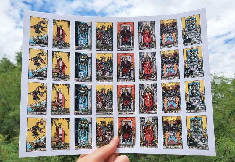 May include: A sheet of paper with 25 tarot cards printed on it. The cards are arranged in five rows of five cards each. Each card features a different tarot card image, including The Fool, The Magician, The Empress, The Emperor, The Hierophant, The Lovers, and The Chariot.