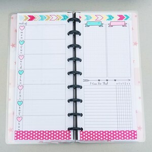 May include: A pink and white weekly planner with a section for "I Can Do That!" and a grid for daily tasks. The planner has a pink polka dot design and a pink and blue arrow design.