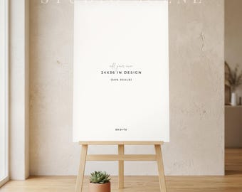 May include: A vertical white rectangular sign on a light wooden easel. The sign features the text "add your own 24X36 IN DESIGN (50% SCALE)" and "DE-DI-TU". A small green succulent in a terracotta pot sits on the floor in front of the easel.