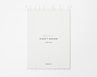 May include: A white rectangular paper mockup featuring the text MOCKUP at the top, add your own 21X29.7 DESIGN (ISO A4) in the center, and DE-DI-TU at the bottom. The paper is oriented vertically with a clean, plain surface for digital design display.