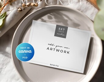 May include: A white 5x7 inch landscape mockup card with the text "add your own ARTWORK" on a beige plate. The card is labeled "5x7 inch mockup" and "EDIT IN canva + PSD". Dried flowers and greenery are in the background.