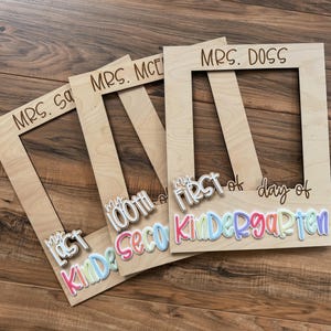 May include: Wooden photo frames with the text "MRS. S", "MRS. MCE", and "MRS. DOSS" engraved at the top. The frames have attached text that reads "My Last", "100th", and "First day of Kindergarten" in colourful letters.