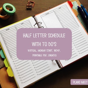 May include: An open planner with a half-letter schedule and to-do lists. The text "HALF LETTER SCHEDULE WITH TO DO'S" is visible. The planner includes a vertical, Monday start, and is undated. Pens and washi tape are also visible.