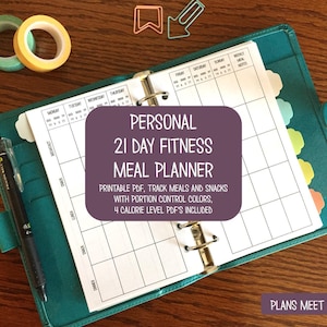 May include: An open teal binder with a meal planner, pen, and washi tape. The planner has a purple overlay with the text "PERSONAL 21 DAY FITNESS MEAL PLANNER." Includes printable PDFs to track meals and snacks. The phrase "PLANS MEET PAPER" is also visible.