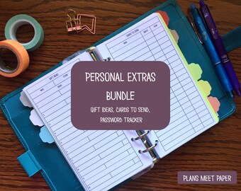 May include: A teal planner with a bundle of personal extras, including gift ideas, cards to send, and a password tracker. The planner is open to a lined page. Decorative tape rolls and pens are also visible.