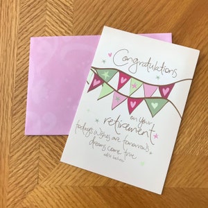 May include: A pink and white card with a banner of flags that says "Congratulations on your retirement." The text below the banner says "Today's wishes are tomorrow's dreams come true." The card is signed "Adele Basheer."