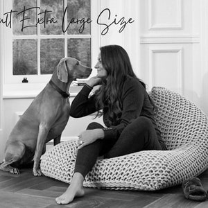 woman sat on extra large size bean bag with dog