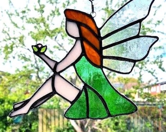Stained glass fairy with flower bud in hand