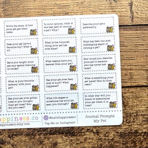 May include: A sheet of journal prompts for pet owners. Each prompt is in a small rectangular box with a cartoon dog illustration. The prompts include questions about pet names, favorite toys, and memories.