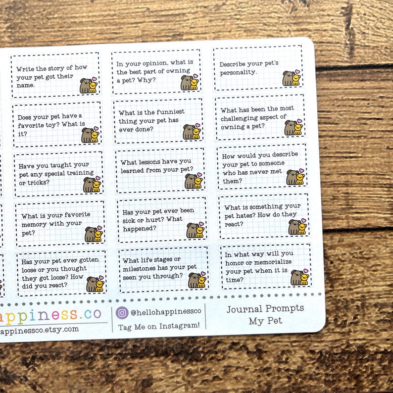 May include: A sheet of journal prompts for pet owners. Each prompt is in a small rectangular box with a cartoon dog illustration. The prompts include questions about pet names, favorite toys, and memories.