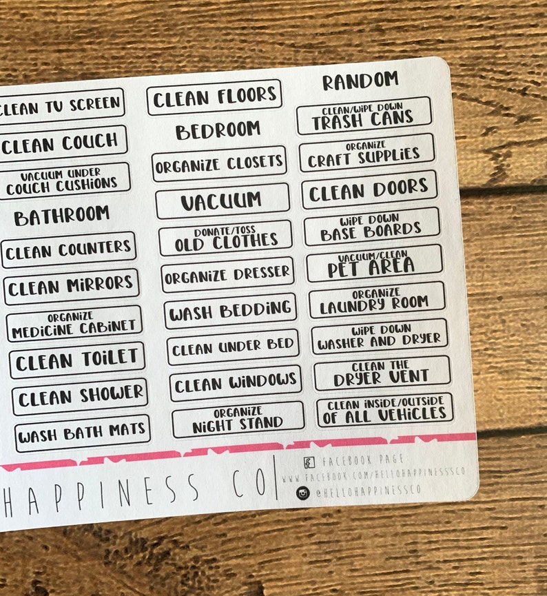 May include: A sheet of white rectangular labels with black text for home organisation. Labels include "Clean Floors", "Bedroom", "Organise Closets", "Vacuum", and "Clean Doors". The bottom of the sheet has the text "Happiness Co".