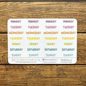 May include: A sheet of colorful stickers with the days of the week written in a funky font. The stickers are in shades of pink, yellow, orange, and blue. The text on the stickers reads "MONDAY", "TUESDAY", "WEDNESDAY", "THURSDAY", "FRIDAY", "SATURDAY", and "SUNDAY".
