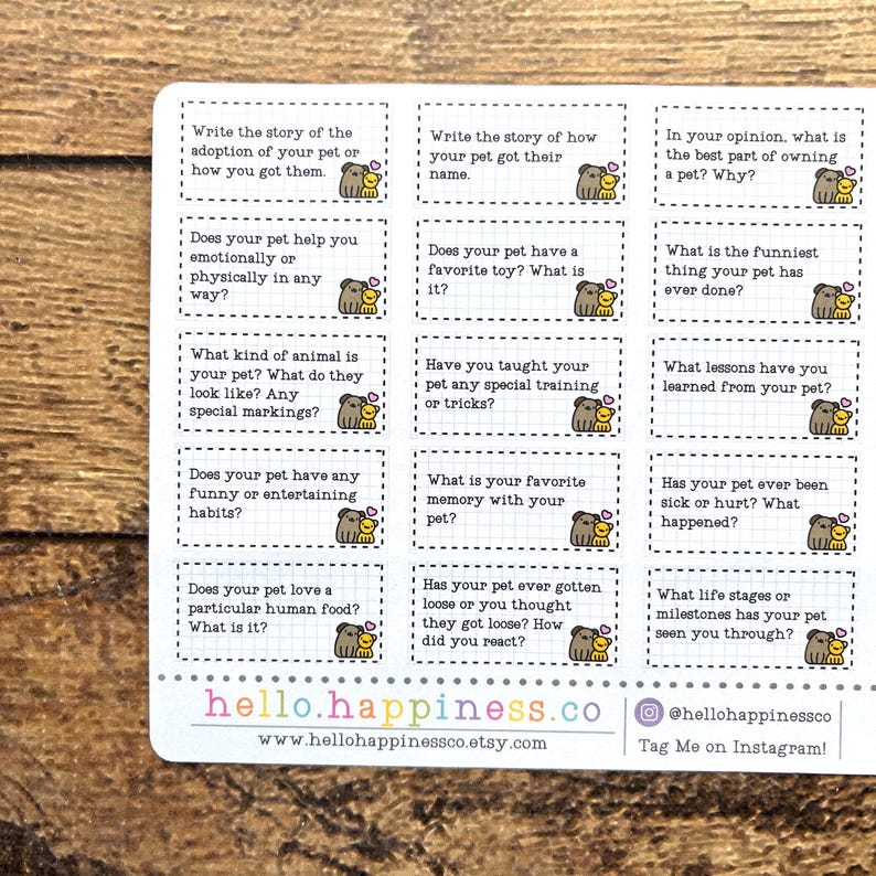 May include: A sheet of stickers with prompts about pets. Each prompt is in a white box with a brown dog illustration. The text includes questions about pet adoption, habits, and favorite toys. The bottom of the sheet has the website hello.happiness.co.