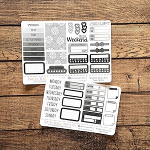May include: Two white sticker sheets with black text and graphics. One sheet has labels like "Important," "To Do," and "Today." The other sheet has labels for each day of the week. The text "Hello Weekend" is also visible.