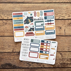 May include: Two sticker sheets with a celestial moths theme. One sheet has labels like "Important" and "To Do", the other has days of the week. The stickers feature moth illustrations, hearts, and text like "Hello Weekend".