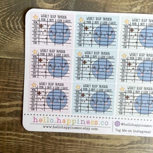 May include: Nine pastel blue and pink stickers with a weekly sleep tracker. Each sticker features a cartoon planet with a smiling face and a grid for tracking sleep quality. The stickers are labeled "Weekly Sleep Tracker" and have a scale of "Poor, Okay, Good, Great".