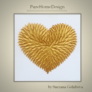 May include: A square wall art piece featuring a textured gold heart shape composed of numerous individual leaf-like elements against a plain white background. The text PureHomeDesign appears at the top and by Snezana Golubova at the bottom.
