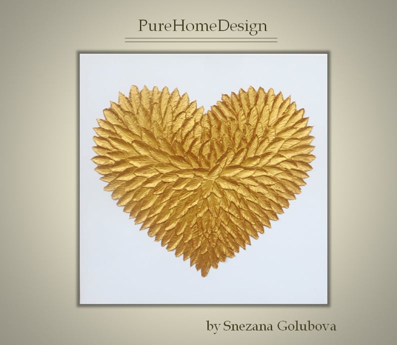 May include: A square wall art piece featuring a textured gold heart shape composed of numerous individual leaf-like elements against a plain white background. The text PureHomeDesign appears at the top and by Snezana Golubova at the bottom.