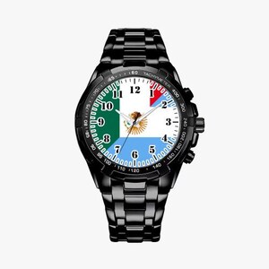 May include: A black wristwatch with a black band and a round face. The face has a white background with black numbers and a flag design in the center. The flag is green, white, and blue.