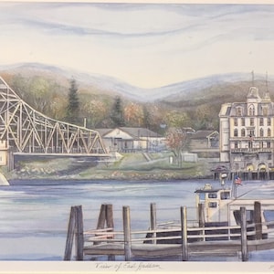 May include: A watercolor painting of a view of East Haddam, Connecticut. The painting features a wooden bridge over a river, a white building with a red roof, and a boat docked at a pier. The painting is signed by the artist, A. Hardy.