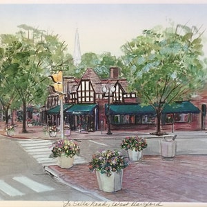 May include: Watercolor painting of La Salle Road in West Hartford. The street scene features a crosswalk, buildings with green awnings, and trees. White flower pots line the sidewalk. A sign reads "New West". The artwork is signed and numbered.
