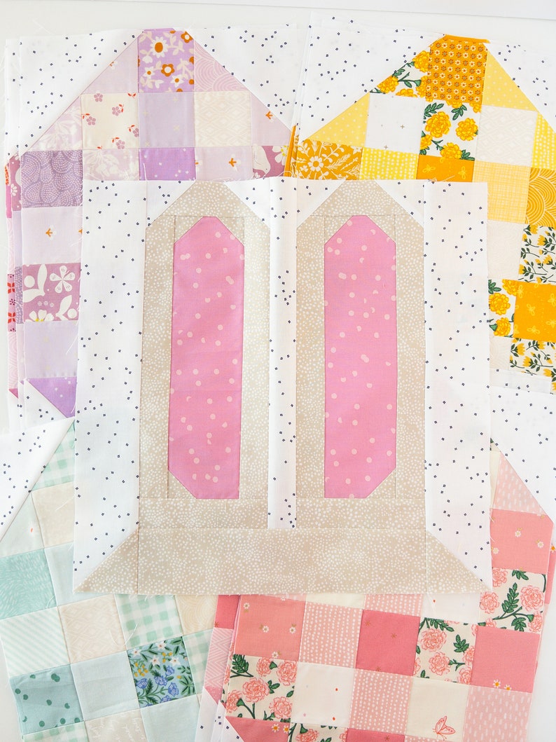 A colorful quilt block arrangement featuring pink and beige bunny ears at the center, surrounded by patchwork in pastel shades and floral patterns, creating a playful and cheerful tone.