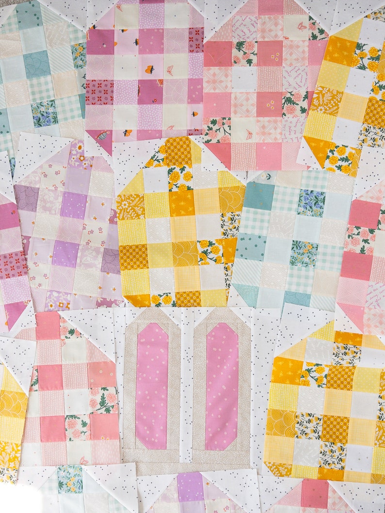A colorful quilt block arrangement featuring pink and beige bunny ears at the center, surrounded by patchwork in pastel shades and floral patterns, creating a playful and cheerful tone.