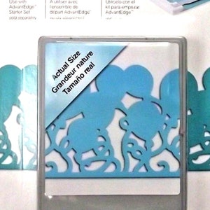 May include: Fiskars decorative border punch cartridge. The cartridge features a blue Mickey Mouse-themed design. The package includes text in English, French, and Spanish, and states "Actual Size".