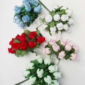 May include: Assortment of five bunches of artificial flowers. Each bunch contains 12 small, fabric roses with green plastic leaves and stems. The roses are in the colors blue, white, red, pink, and light green.