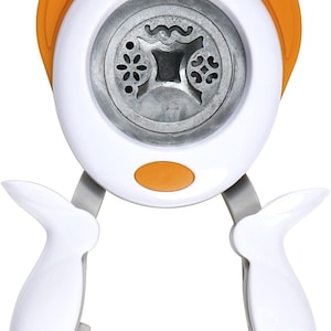 May include: White and orange paper punch with two handles. The punch has a circular cutting area with three different designs: a flower, a wavy line, and a heart.