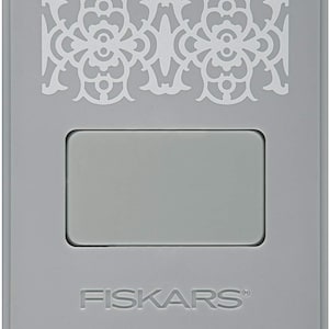 May include: Gray metal craft punch with a decorative design on the top and the word "FISKARS" printed on the bottom.