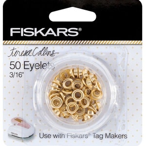 May include: A package of 50 gold eyelets, 3/16" in size, for use with Fiskars Tag Makers. The eyelets are in a clear plastic container.