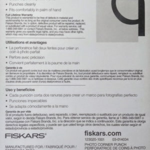 May include: A white and black Fiskars photo corner punch with a lifetime warranty. The punch is designed to create a perfect photo frame with two slots. The packaging includes instructions in English, French, and Spanish. The product is manufactured in Korea and distributed by Fiskars Brands, Inc. in Madison, Wisconsin.