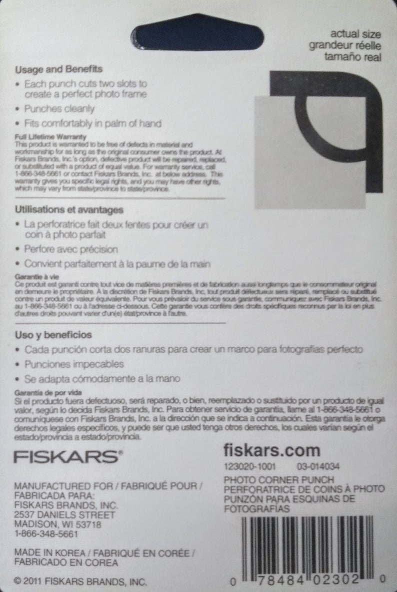 May include: A white and black Fiskars photo corner punch with a lifetime warranty. The punch is designed to create a perfect photo frame with two slots. The packaging includes instructions in English, French, and Spanish. The product is manufactured in Korea and distributed by Fiskars Brands, Inc. in Madison, Wisconsin.