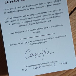 May include: A blue card with the title "Le Tarot des Paysages Int&eacute;rieurs" and text in French about the tarot deck. The card also includes the signature "Camille" and the number "1/108" printed on the bottom.