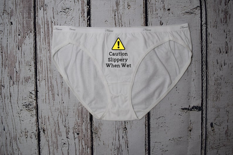 Caution slippery when wet design shown on a white bikini style underwear.