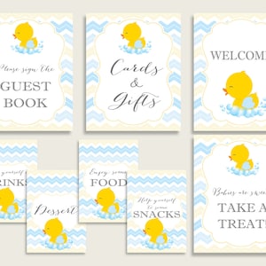 May include: A set of nine printable baby shower signs featuring a yellow rubber ducky with blue and white chevron background. The signs include "Welcome", "Guest Book", "Cards & Gifts", "Drinks", "Dessert", "Food", "Snacks", and "Take a Treat!"
