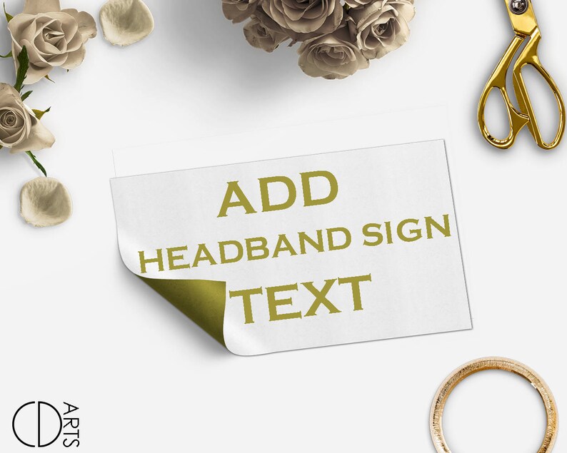 May include: A white card with the text "ADD HEADBAND SIGN TEXT" in gold letters. The card is partially folded over, revealing a gold background.