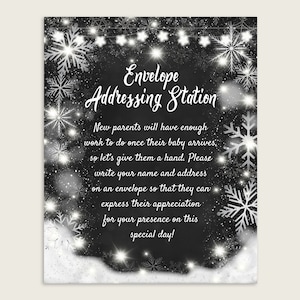 May include: Black and white printable sign with a winter theme. The sign says "Envelope Addressing Station" and includes the text "New parents will have enough work to do once their baby arrives, so let's give them a hand. Please write your name and address on an envelope so that they can express their appreciation for your presence on this special day!"