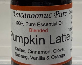 May include: A brown glass bottle of "Pumpkin Latte" essential oil. The label includes the text "Uncanoonuc Pure" and lists ingredients like coffee, cinnamon, and vanilla. The bottle has a black cap and contains 15 ml of oil.