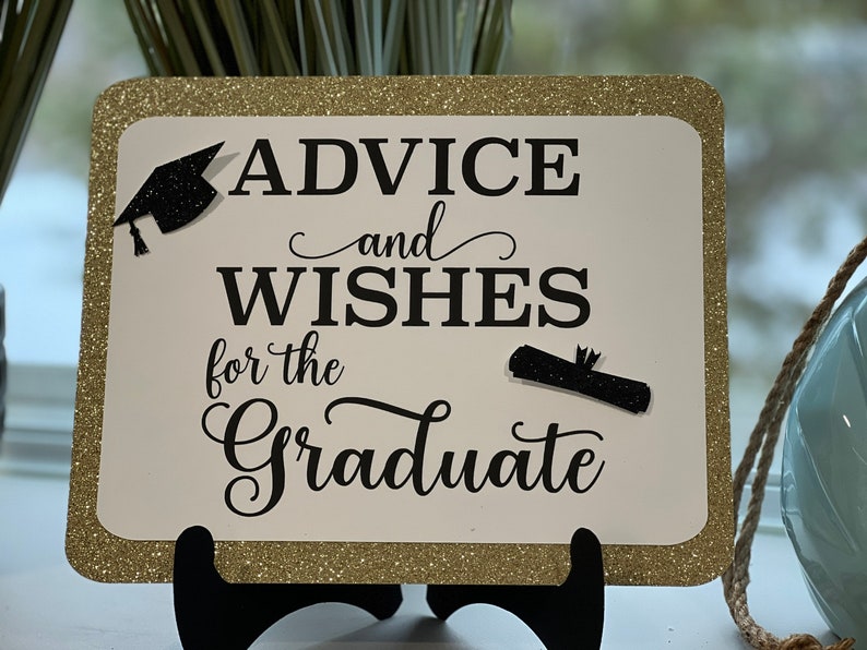 Peut inclure: Une pancarte dor&eacute;e &agrave; paillettes avec du texte noir qui dit "Conseils et v&oelig;ux pour le dipl&ocirc;m&eacute;". La pancarte a un bonnet de dipl&ocirc;m&eacute; noir et un dipl&ocirc;me graphique.