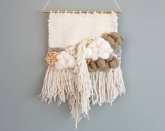 Woven Wall Hanging, with a lot of texture and fluffy clouds. Neutral colors like olive green, grey and ivory.Including raffia.Ready to ship!