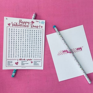 May include: A Valentine's Day card with a word search puzzle featuring the words "Happy Valentine's Day!" and "I think you're: Fantastic, Magnificent, Smart, Spectacular, Super, Terrific, Wonderful". The card is pink and white with hearts.