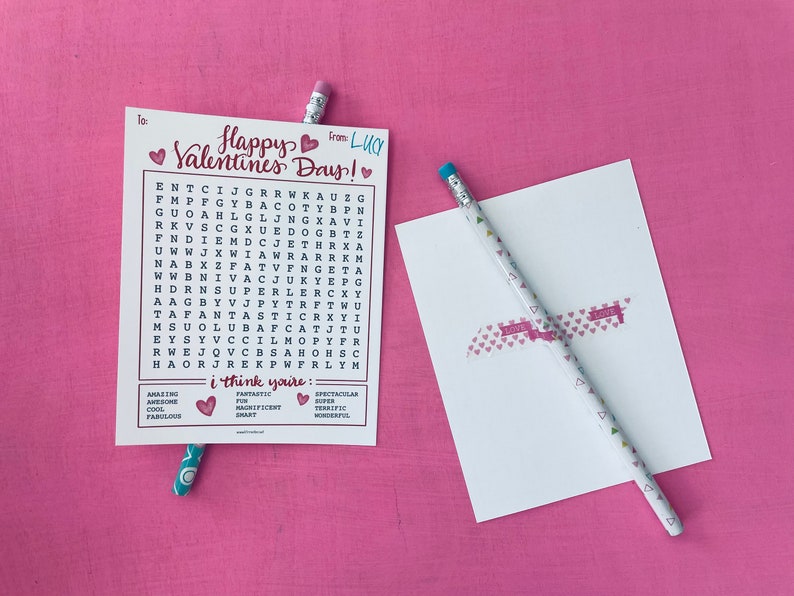 May include: A Valentine's Day card with a word search puzzle featuring the words "Happy Valentine's Day!" and "I think you're: Fantastic, Magnificent, Smart, Spectacular, Super, Terrific, Wonderful". The card is pink and white with hearts.