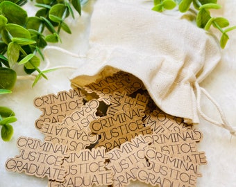 May include: A brown paper bag filled with brown paper stickers that say "Criminal Justice Graduate" in black text.