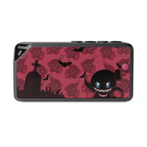 May include: A rectangular black Bluetooth speaker with a red camouflage pattern. The speaker features a Halloween-themed design with bats, a tombstone, and a cartoon monster. The word "Bluetooth" is printed on the top left corner.