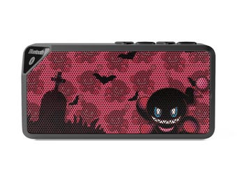 May include: A rectangular black Bluetooth speaker with a red camouflage pattern. The speaker features a Halloween-themed design with bats, a tombstone, and a cartoon monster. The word "Bluetooth" is printed on the top left corner.