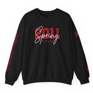 May include: Black sweatshirt with red text that says "2011 Spring" and "28-TO-L.I.F.E." The sleeves have red text that says "2011" repeated down the sleeves.
