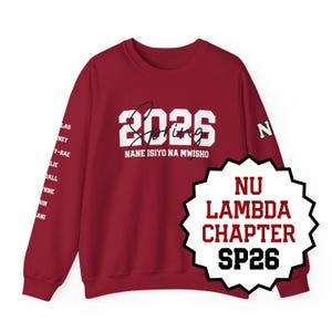 May include: A maroon sweatshirt with white text that reads "2026 Spring" and "NANE ISIYO NA MWISHO". The right sleeve has a list of names. A black and white badge reads "NU LAMBDA CHAPTER SP26".