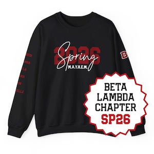 May include: Black sweatshirt with the text "Spring 2026 M.A.Y.H.E.M." in white script and red block letters. A red and white Beta Lambda Chapter SP26 logo is on the lower right. The left sleeve has names in red.